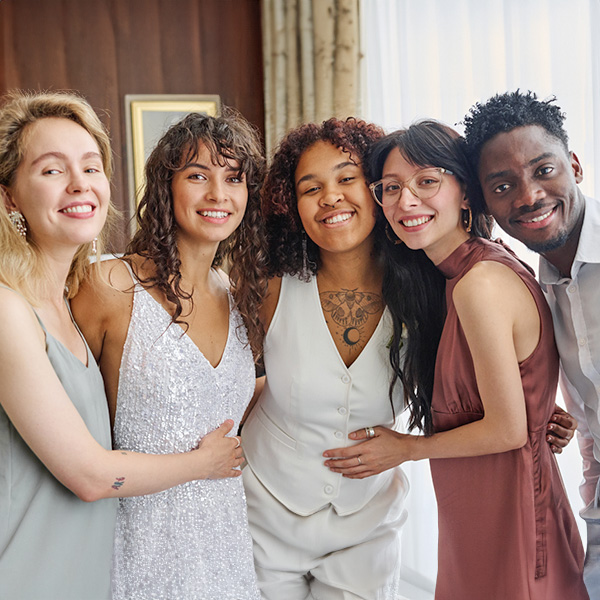 Four girls and a guy friend smiling on a photo at a party